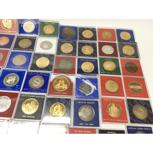 765 - A large collection of assorted commemorative medals including many 22ct gold plated examples. Postag... 