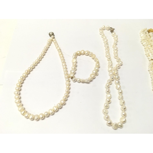 772 - A collection of natural pearl necklaces and a bracelet. Postage B