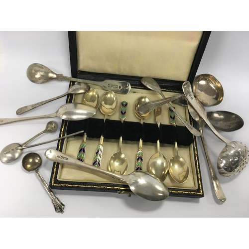 776A - A cased set of enamel spoons together with a silver tea caddy spoon and various other spoons