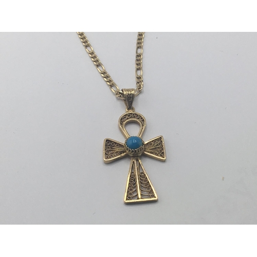 779 - An 18carat gold gold open link necklace with attached gold filigree cross set with turquoise. Weight... 