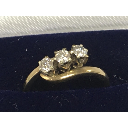 791 - A 9ct gold ring inset with a row of three diamonds