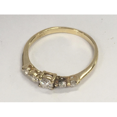 792 - An 18ct yellow gold ring inset with a row of five small diamonds