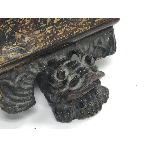 801 - A Chinese black lacquer box with gilt decoration and dragon head feet, dimensions 25x19x16cm approxi... 