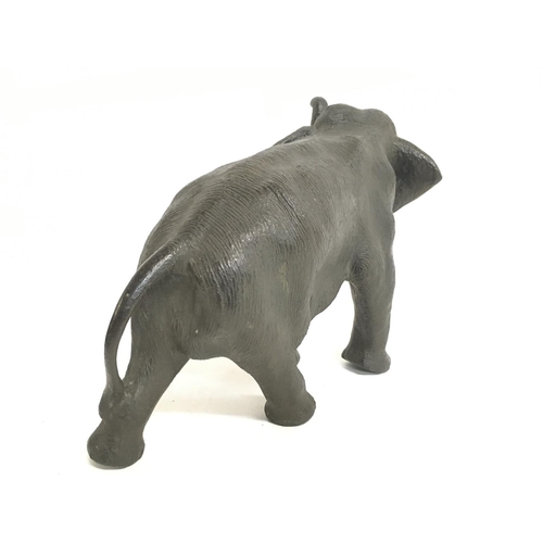 824 - A Meiji period Japanese bronze elephant figure with bone tusks, 18cm tall. Postage category C