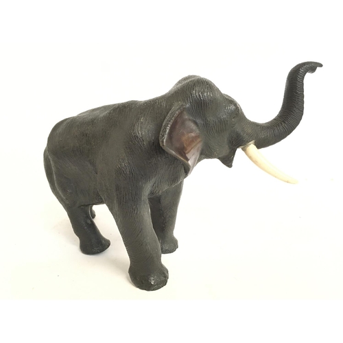 824 - A Meiji period Japanese bronze elephant figure with bone tusks, 18cm tall. Postage category C