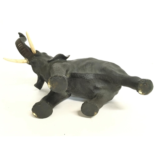 824 - A Meiji period Japanese bronze elephant figure with bone tusks, 18cm tall. Postage category C