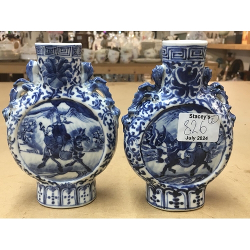 826 - A matched pair of 19th Century blue and white moon vases decorated with figures on horseback. Measur... 