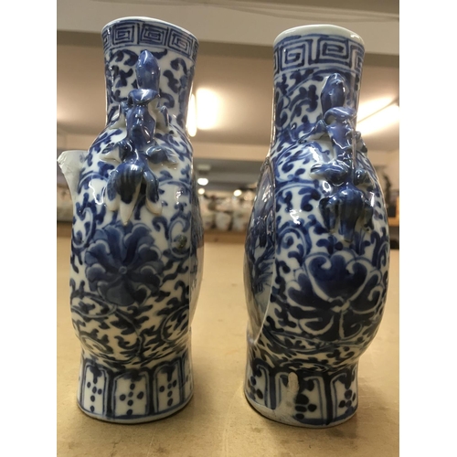 826 - A matched pair of 19th Century blue and white moon vases decorated with figures on horseback. Measur... 