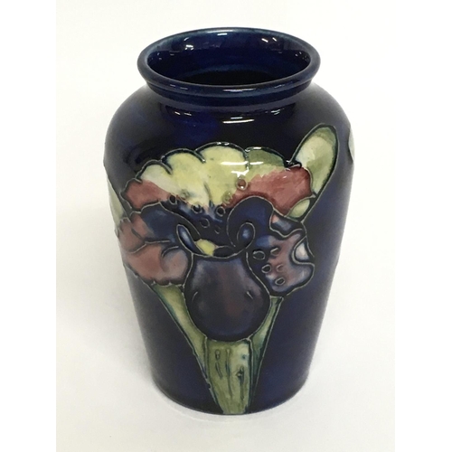 913 - A small Moorcroft vase, 9.5cm tall. No obvious damage or restoration, this lot cannot be posted. NO ... 