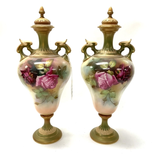 914 - A Pair of Royal Worcester hand painted urns and covers with hand painted Rose decoration signed R.Au... 