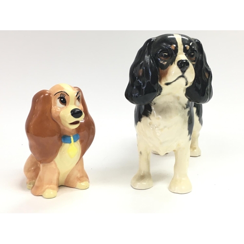 921 - Porcelain figures, a beswick dog and a Disney china lady figure. 13 & 9cm tall. No obvious damage or... 