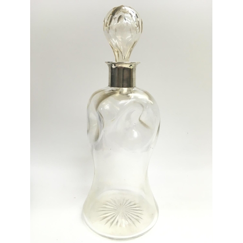 933 - An unusual early 20th century waisted glass decanter and stopper with a hallmarked silver collar