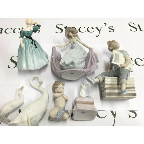 952 - A collection of seven figures including Lladro NAO and Royal Doulton. Postage D.