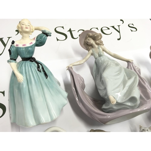 952 - A collection of seven figures including Lladro NAO and Royal Doulton. Postage D.