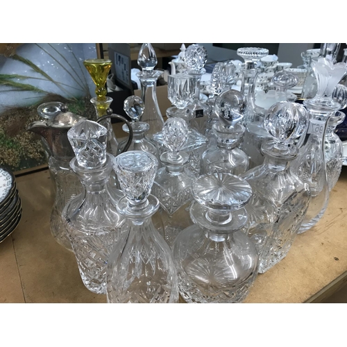 967 - A large collection of decanters including some glass cut and silver plated examples. Approximately 2... 