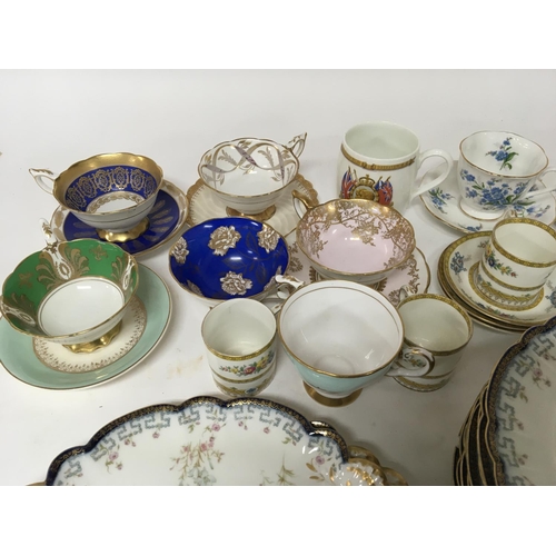 970 - A French Porcelain dinner service and a quantity of porcelain cups a d saucers.