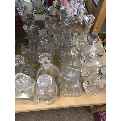 973 - A large collection of decanters including cut glass examples. Approx 20 decanters.