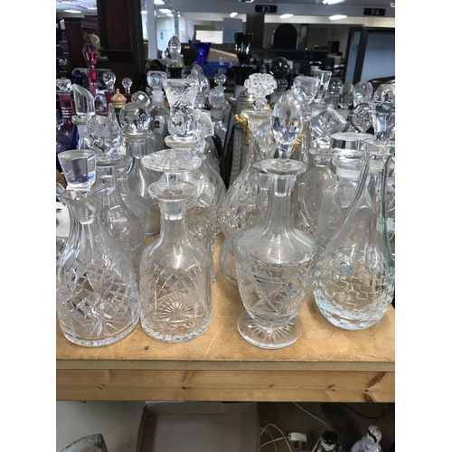 983 - A large collection of cut glass decanters. Approx 20 decanters.