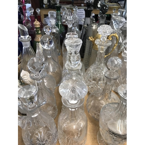 983 - A large collection of cut glass decanters. Approx 20 decanters.