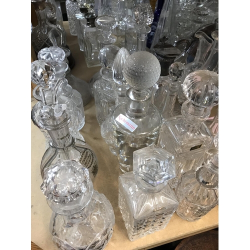 985 - A large collection of cut glass decanters. Approx 20 decanters.