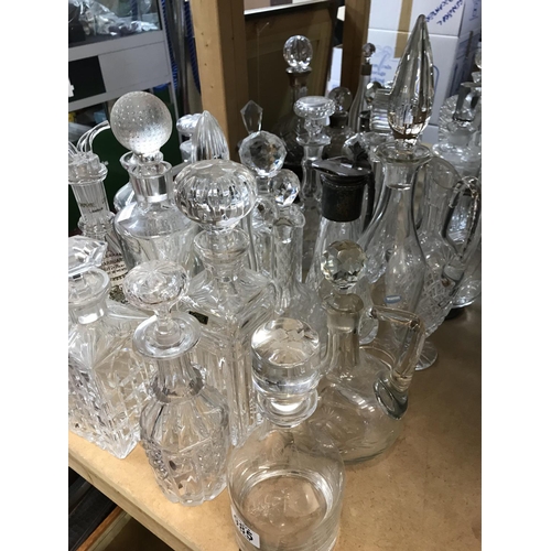 985 - A large collection of cut glass decanters. Approx 20 decanters.