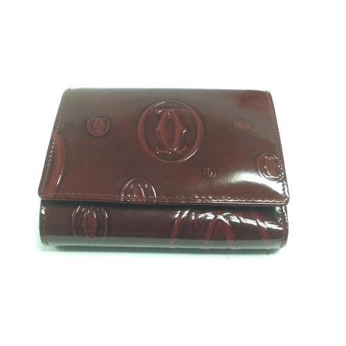 802 - A boxed Cartier leather purse, as new, with outer bag, card and booklet. Shipping category B.