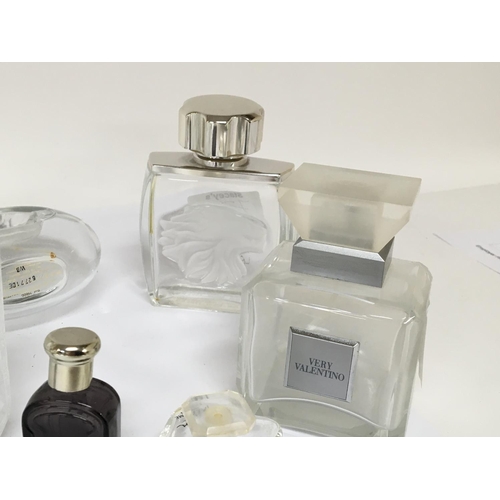 810 - A collection of quality Lalique and other designer glass scent bottles.
