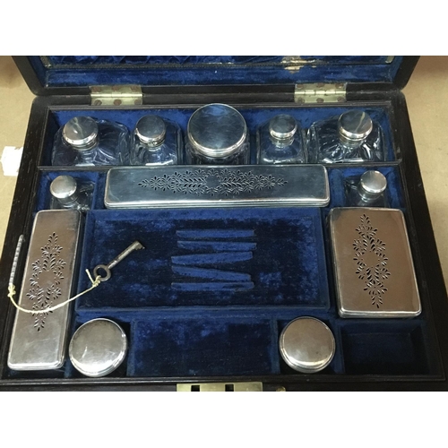 825 - A George IV Rosewood and brass bound travelling toilet box with fitted interior including glass jars... 