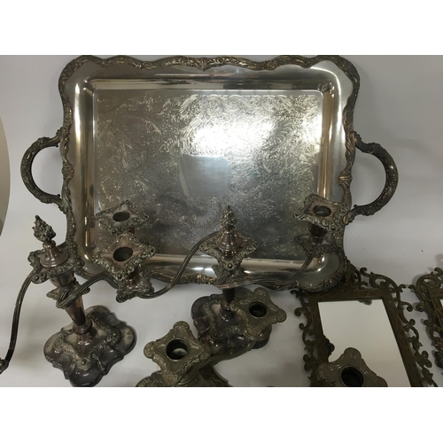 827 - A pair of brass Girondelle a collection of candle sticks and candelabra a French style clock and a s... 