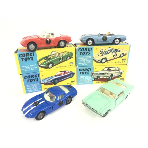 165 - 7 X Boxed Corgi Vehicles. A Lotus Elan Coupe #319. A Lotus Elan S2 #318 A/F. A Marcos 1800 G.T. #324... 