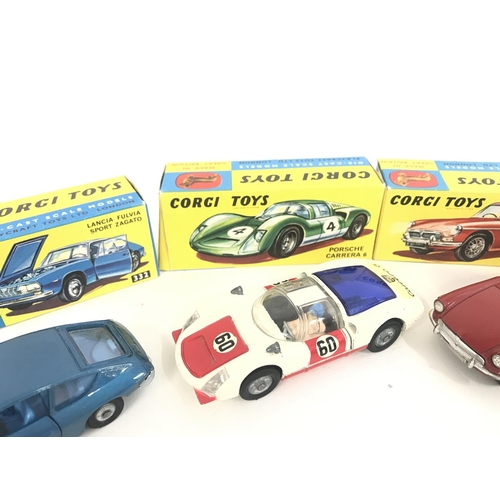 165 - 7 X Boxed Corgi Vehicles. A Lotus Elan Coupe #319. A Lotus Elan S2 #318 A/F. A Marcos 1800 G.T. #324... 