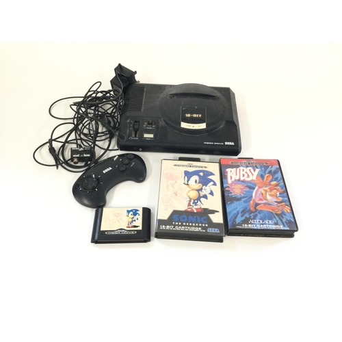 303 - A bag containing a SEGA mega drive, including 1 controller, 2 Boxed games and 1 loose game.