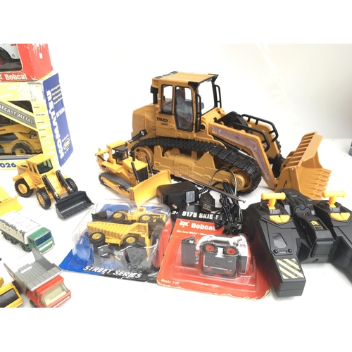 343 - A Collection of Boxed And Loose Construction Vehicles Including a R/C Digger. Matchbox Etc. NO RESER... 