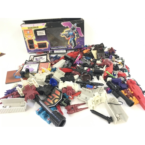 35 - A collection of Transformers parts and accessories including an empty box and numerous instruction b... 