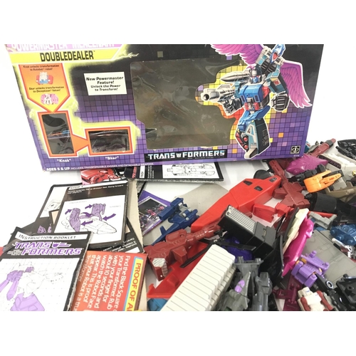 35 - A collection of Transformers parts and accessories including an empty box and numerous instruction b... 