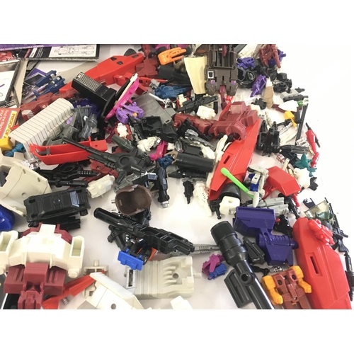 35 - A collection of Transformers parts and accessories including an empty box and numerous instruction b... 