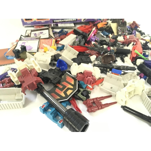 35 - A collection of Transformers parts and accessories including an empty box and numerous instruction b... 