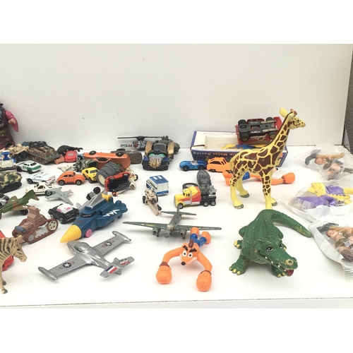 381 - An assorted collection of items including animals, vehicles and figures. NO RESERVE
