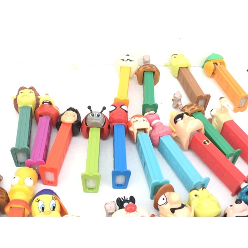 386 - A collection in excess of 40 PEZ sweet dispensers of varying ages and made in several countries. Fea... 