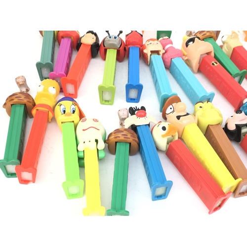386 - A collection in excess of 40 PEZ sweet dispensers of varying ages and made in several countries. Fea... 