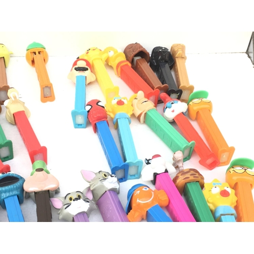 386 - A collection in excess of 40 PEZ sweet dispensers of varying ages and made in several countries. Fea... 