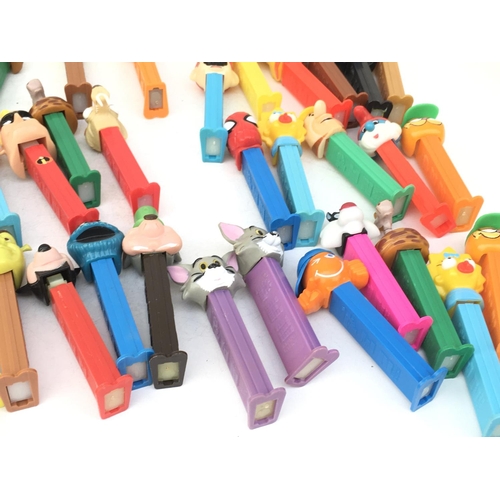 386 - A collection in excess of 40 PEZ sweet dispensers of varying ages and made in several countries. Fea... 