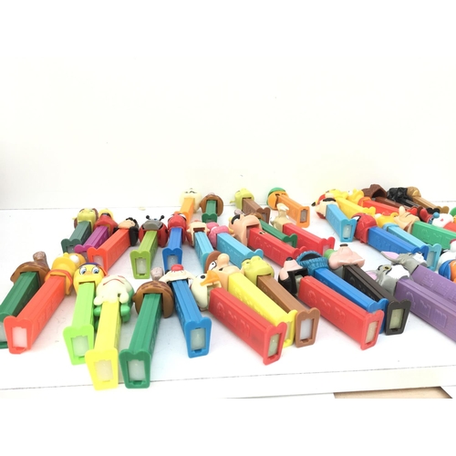 386 - A collection in excess of 40 PEZ sweet dispensers of varying ages and made in several countries. Fea... 
