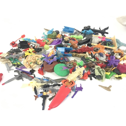 55 - An assorted collection in excess of 100 pieces of parts and accessories from various toy lines in th... 