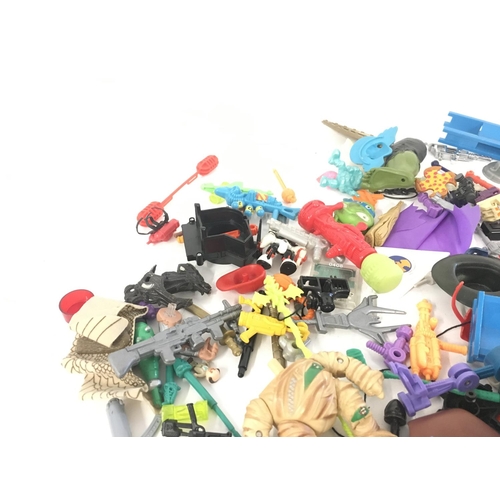 55 - An assorted collection in excess of 100 pieces of parts and accessories from various toy lines in th... 