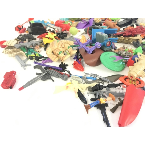 55 - An assorted collection in excess of 100 pieces of parts and accessories from various toy lines in th... 