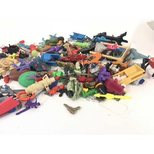 55 - An assorted collection in excess of 100 pieces of parts and accessories from various toy lines in th... 