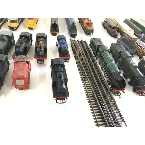 97 - A collection of model railway engines..carriages ..wagons and track. All 00 gauge. Makers include Ho... 