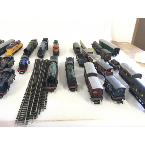 97 - A collection of model railway engines..carriages ..wagons and track. All 00 gauge. Makers include Ho... 