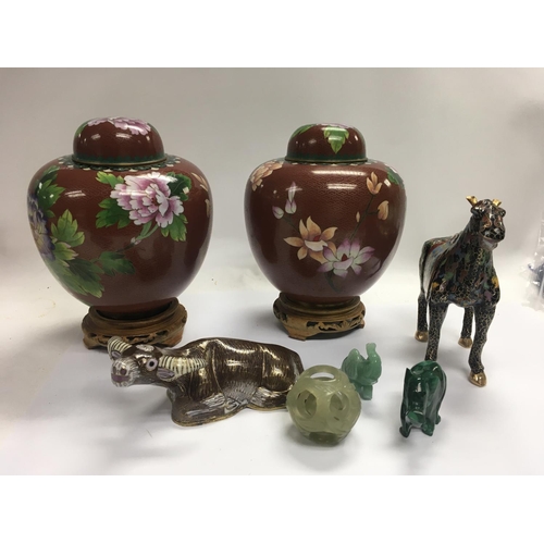 1039 - A collection of cloisonnÃ© figures and vases with stands and some jade figures.